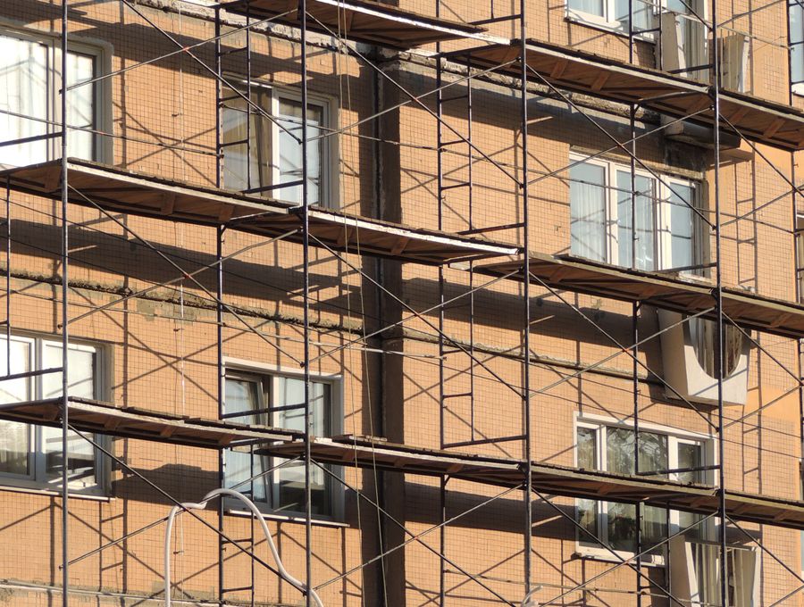 Scaffolding up the front of a brick block of flats