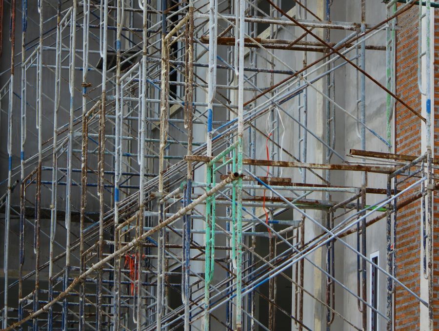 Tube and fitting scaffolding against a brick wall